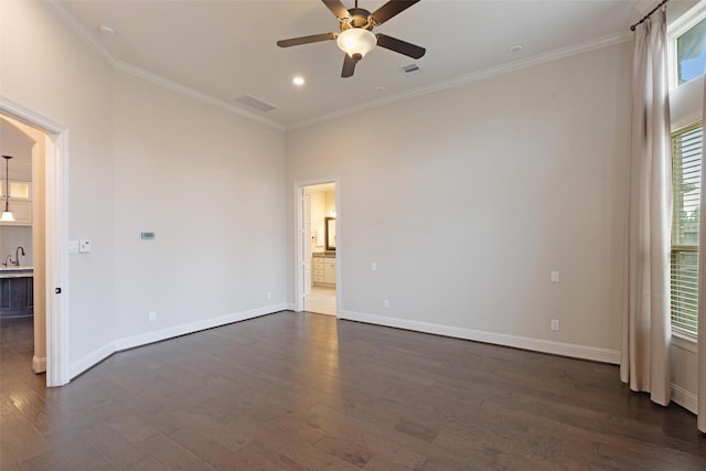 spare room featuring crown molding, ceiling fan, and dark hardwood / wood-style floors