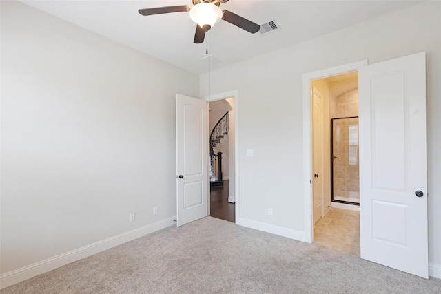 unfurnished bedroom featuring light carpet and ceiling fan