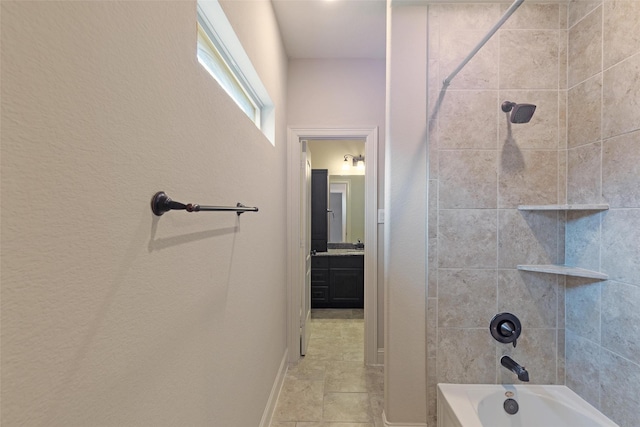 bathroom featuring vanity, tile patterned floors, and tiled shower / bath