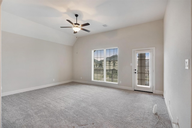 carpeted empty room with ceiling fan and lofted ceiling