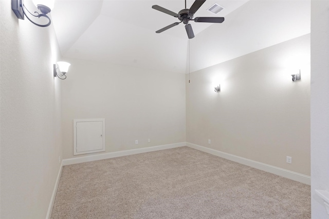 carpeted spare room with ceiling fan and lofted ceiling