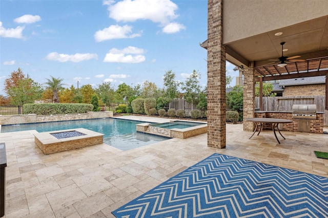 view of swimming pool with an outdoor kitchen, ceiling fan, an in ground hot tub, a grill, and a patio area