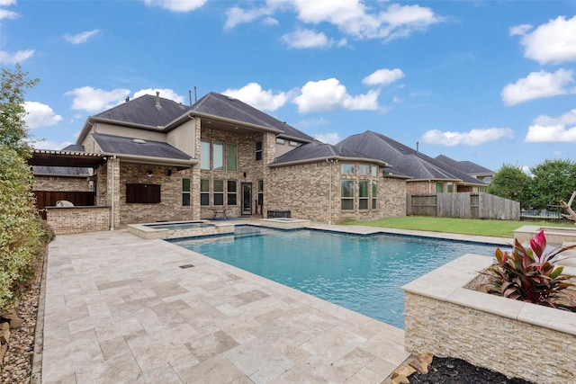 view of pool with a patio area and an in ground hot tub