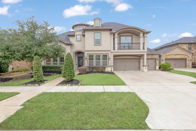 view of front of home with a balcony, a garage, and a front lawn