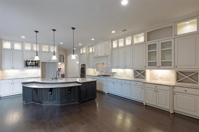 kitchen featuring white cabinetry, a kitchen island with sink, and appliances with stainless steel finishes