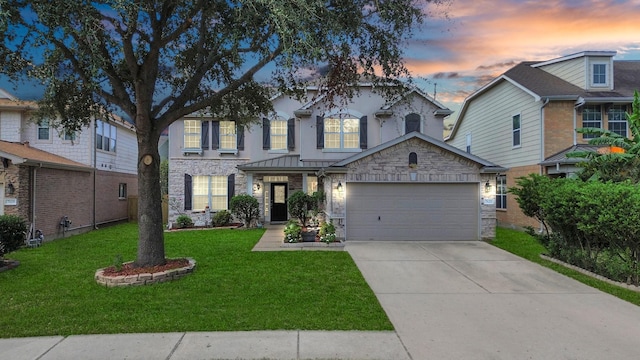 view of front of house featuring a lawn and a garage