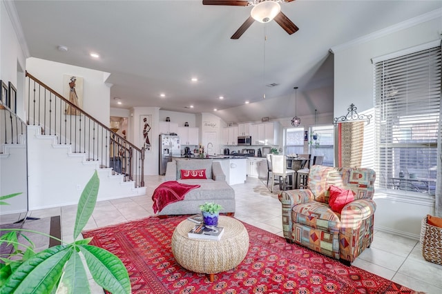 tiled living room with vaulted ceiling, ceiling fan, ornamental molding, and sink