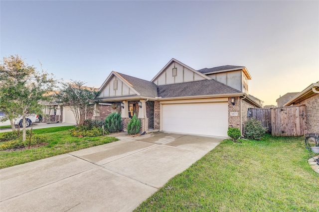 view of front of property with a garage and a lawn