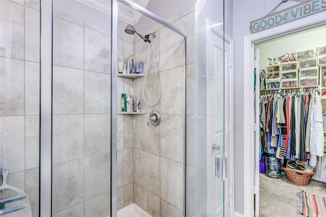 bathroom with a shower with door