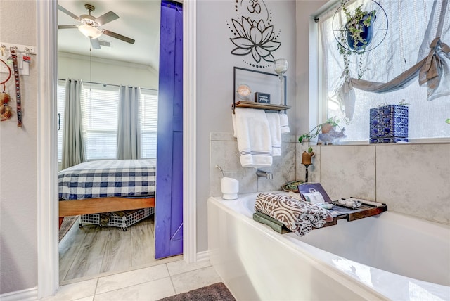 bathroom featuring tile patterned floors, crown molding, a bathtub, and ceiling fan