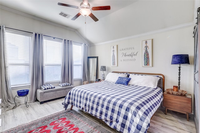 bedroom featuring ceiling fan, ornamental molding, vaulted ceiling, and hardwood / wood-style flooring