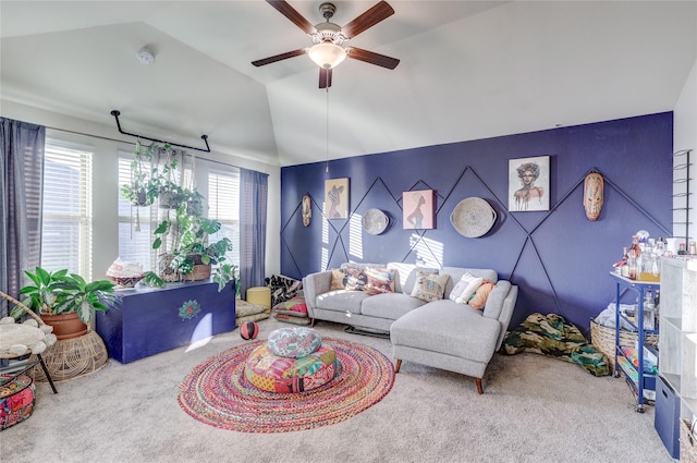 carpeted living room featuring ceiling fan and vaulted ceiling