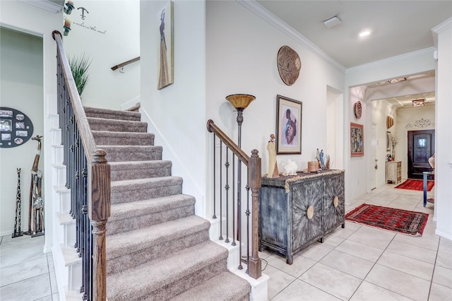 stairway with tile patterned flooring and ornamental molding