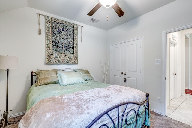 carpeted bedroom featuring a closet, vaulted ceiling, and ceiling fan