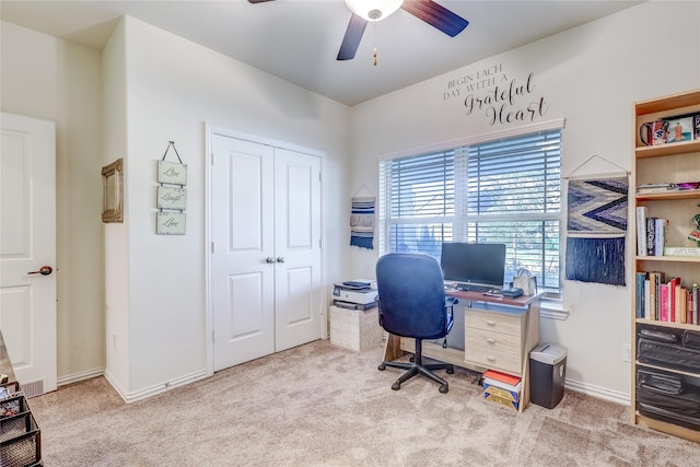 office space with light carpet and ceiling fan