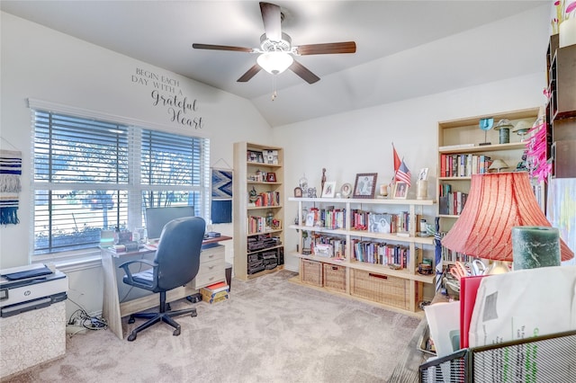 carpeted office space featuring vaulted ceiling and ceiling fan