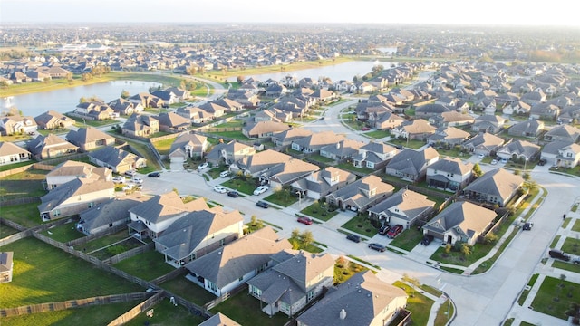 bird's eye view with a residential view and a water view