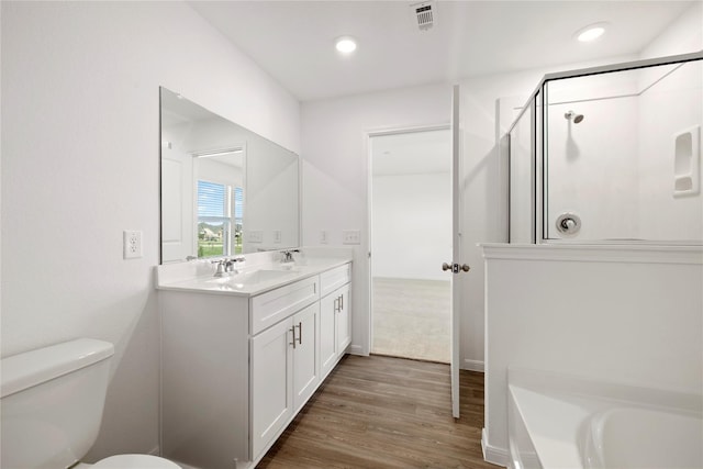 full bathroom featuring vanity, toilet, wood-type flooring, and independent shower and bath