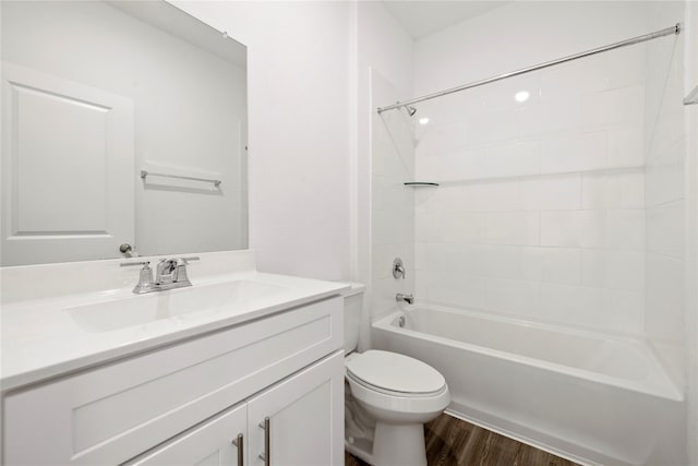 full bathroom featuring vanity, hardwood / wood-style flooring, toilet, and tiled shower / bath