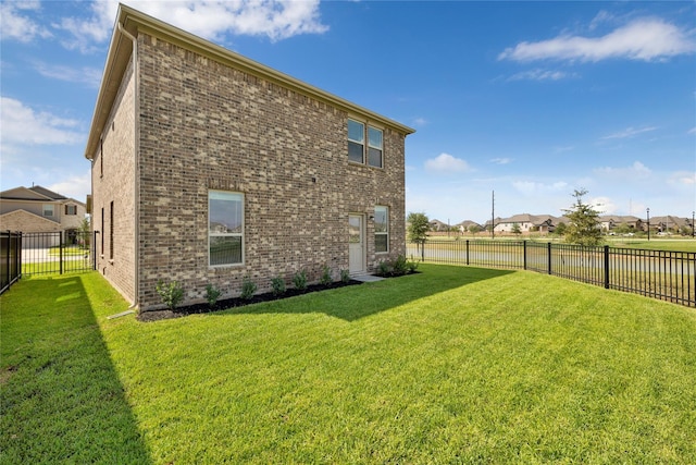 rear view of house with a yard