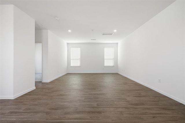 spare room featuring dark hardwood / wood-style floors