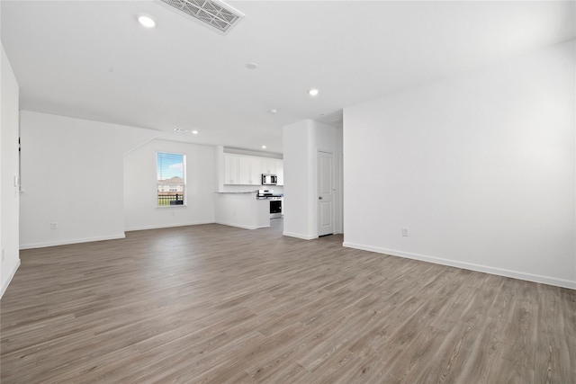 unfurnished living room featuring light hardwood / wood-style floors