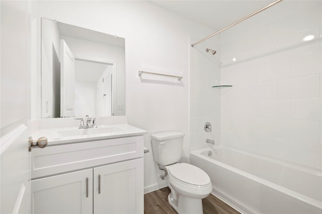 full bathroom with vanity, wood-type flooring, tiled shower / bath combo, and toilet