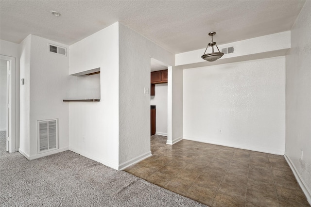 spare room with a textured ceiling and visible vents