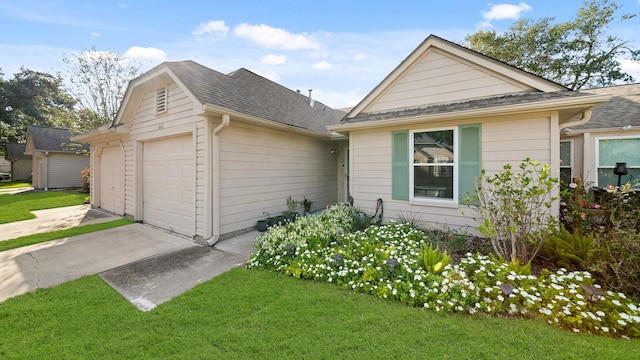 ranch-style house featuring a front yard and a garage