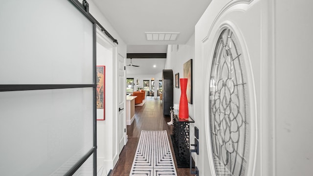 hall featuring a barn door and dark hardwood / wood-style flooring