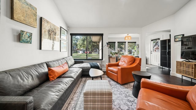 living room with light hardwood / wood-style flooring and lofted ceiling