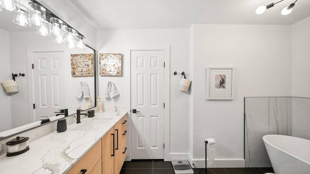 bathroom with tile patterned floors, a bathing tub, and vanity