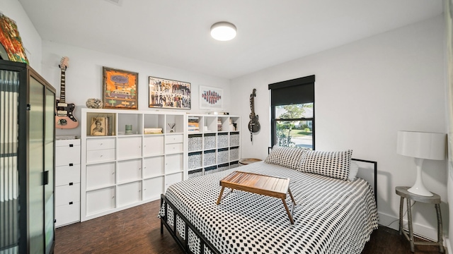 bedroom with dark hardwood / wood-style floors