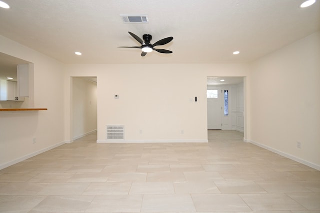 unfurnished living room featuring ceiling fan and light tile patterned floors