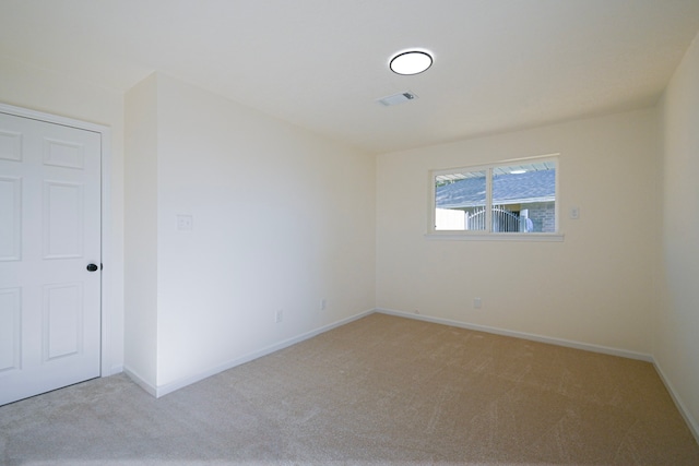 unfurnished room featuring light carpet