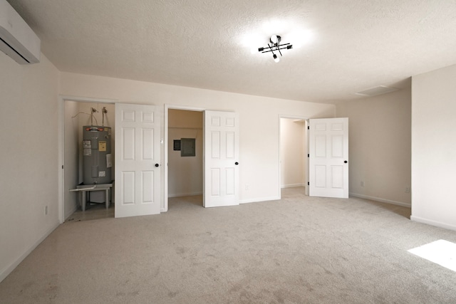 unfurnished bedroom with electric water heater, a wall unit AC, a textured ceiling, light carpet, and a closet