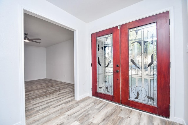 entrance foyer with ceiling fan, french doors, and light hardwood / wood-style flooring