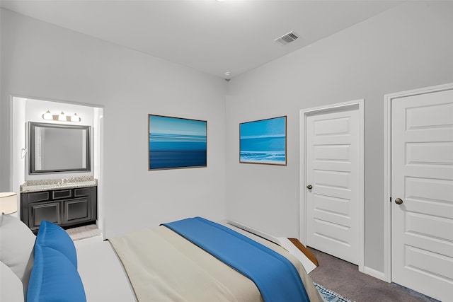 carpeted bedroom featuring ensuite bathroom