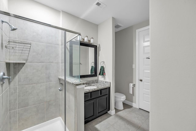 bathroom featuring vanity, toilet, and a shower with shower door