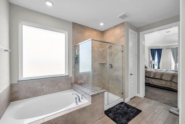 bathroom with shower with separate bathtub