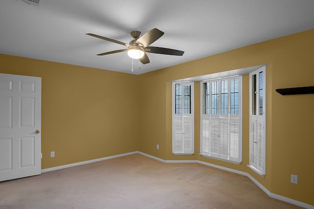 unfurnished room featuring ceiling fan and light colored carpet