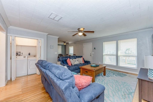 living room with crown molding, washer and clothes dryer, ceiling fan, and light wood-type flooring