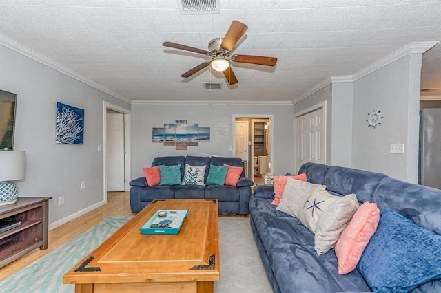 living room featuring crown molding, ceiling fan, and light hardwood / wood-style floors