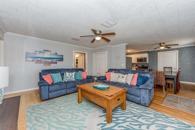 living room with ceiling fan, wood-type flooring, and crown molding