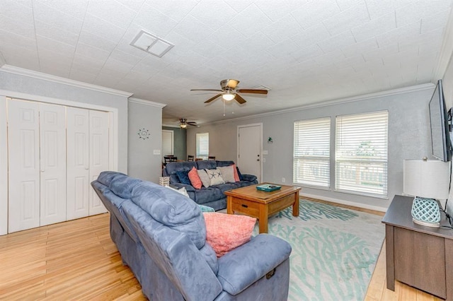 living room featuring ceiling fan, light hardwood / wood-style floors, and ornamental molding