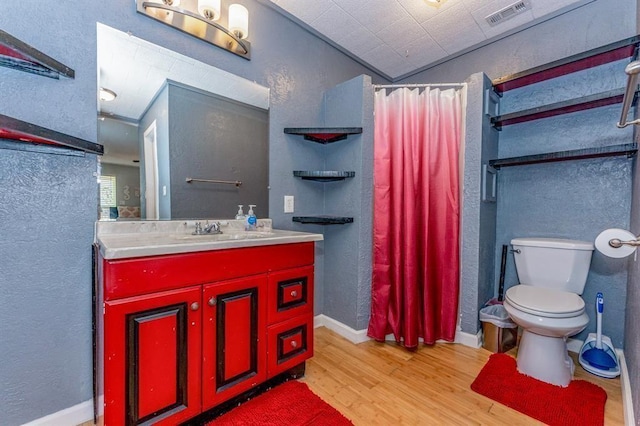 bathroom with vanity, hardwood / wood-style flooring, toilet, and crown molding