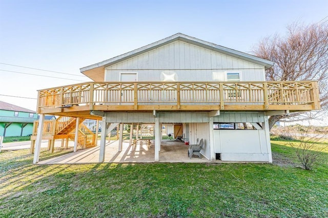 back of house featuring a wooden deck, a yard, and a patio