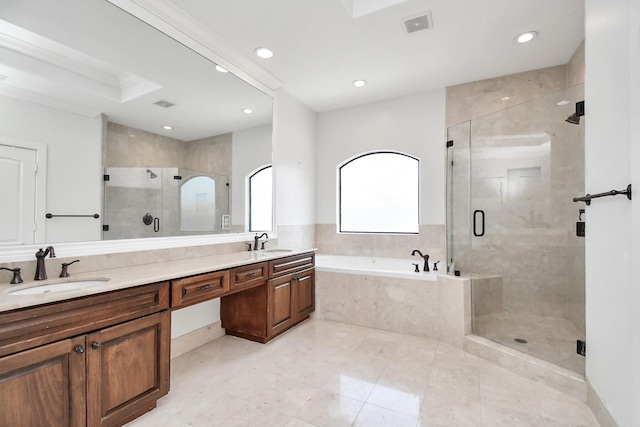 bathroom with vanity and shower with separate bathtub