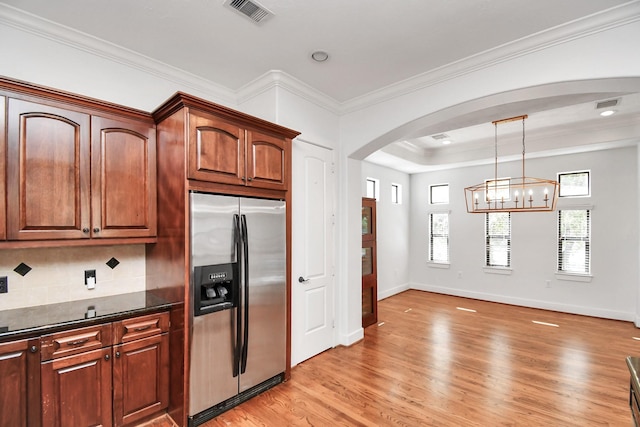 kitchen featuring decorative backsplash, light hardwood / wood-style flooring, decorative light fixtures, and stainless steel refrigerator with ice dispenser