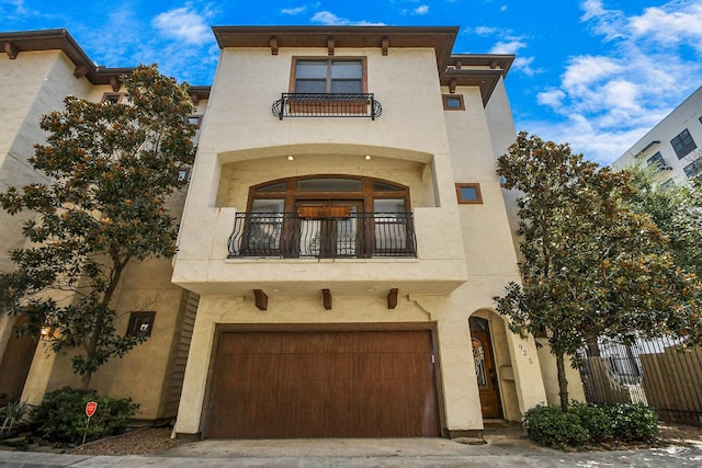 mediterranean / spanish-style home featuring a balcony and a garage